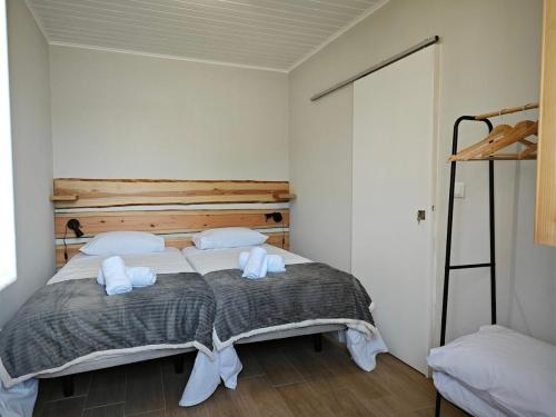 ein Schlafzimmer mit einem Bett mit weißen Kissen und einer Leiter in der Unterkunft Casa da Marta - Azorean Nature Escape in Nordeste