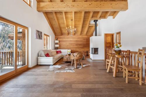 a living room with a couch and a table at Chalet White Peak by Miggins in Grimentz