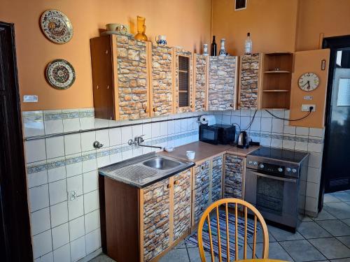 a small kitchen with a sink and a stove at Pod Białym Żaglem in Gdańsk
