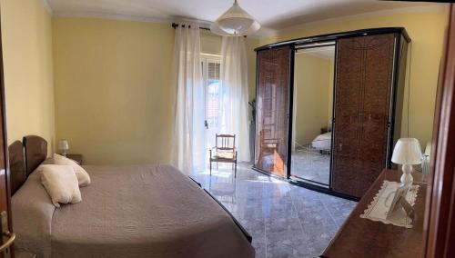 a bedroom with a large bed and a large mirror at Casa Granitto in Castello del Matese