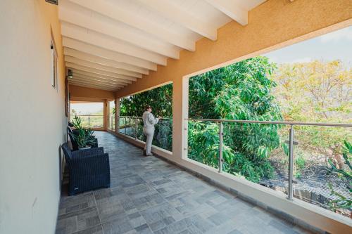 a woman standing on the balcony of a house at Hotel RH Boutique Aruba in Oranjestad
