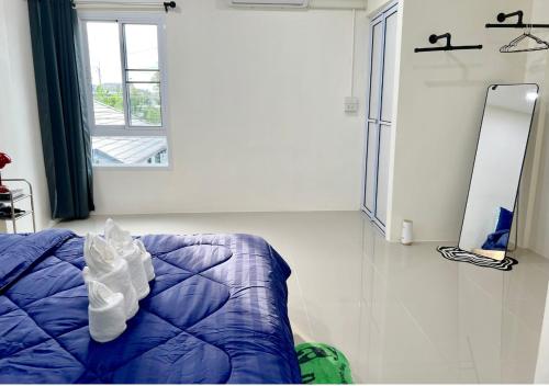 a bedroom with a blue bed and a window at Free Netflix 3BR 10 Mins to City Center 3 Mins 7-11 in Hat Yai