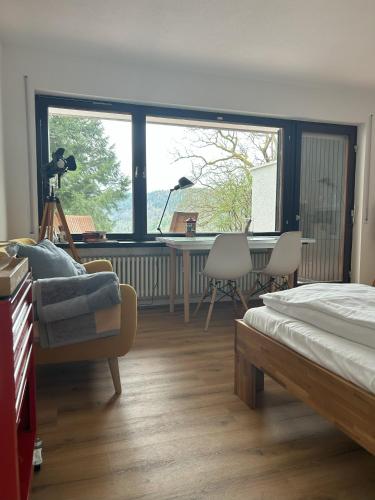 a bedroom with a bed and a desk and a table at Glücks-Quartier Kaffeehof 4 in Bad Liebenzell
