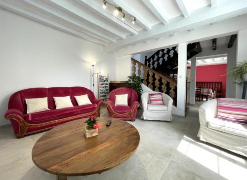 a living room with couches and a wooden table at Etchechoury in Moncayolle-Larrory-Mendibieu