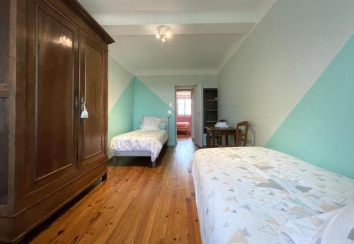 a bedroom with a bed and a dresser at Etchechoury in Moncayolle-Larrory-Mendibieu