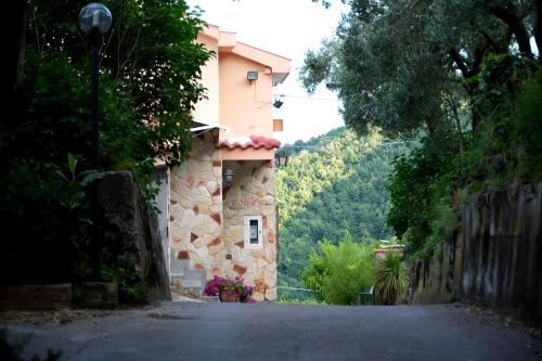 a building on a road next to a house at Seaview Terrace, Nature & Relax with TWO Private Pools - Antica Rocca Dorotea in Salerno