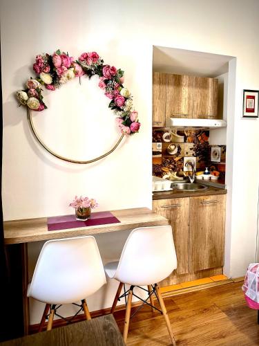 a kitchen with a table with two chairs and a mirror at S&N Apartments Nis in Niš