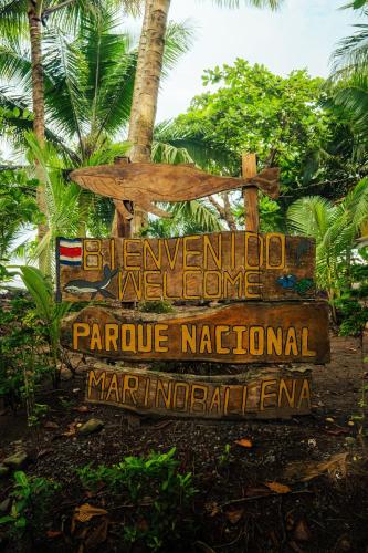 a sign for the hawaiian welcomeorageorageorageorageapaapaapaapa at Bambuk Bio Chalet Uvita Beach Front in Uvita