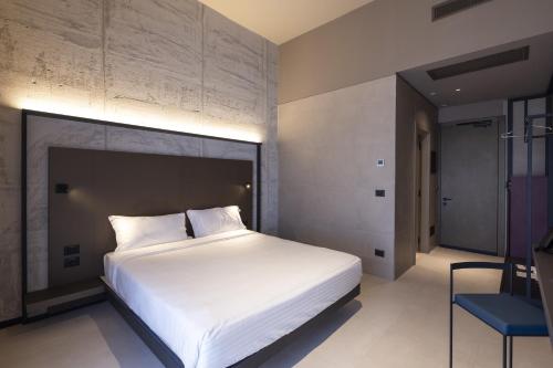 Un ou plusieurs lits dans un hébergement de l'établissement Joy 124 Hotel Milano