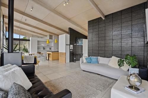 a living room with a couch and a table at Bridge Hill Beauty - Alexandra Holiday Home in Alexandra