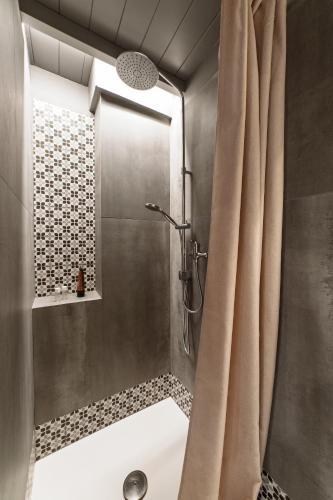 a bathroom with a shower with a shower curtain at Dimora Michelangelo in Alessano