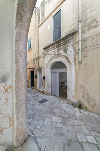 an alley with an archway next to a building at Dimora Michelangelo in Alessano