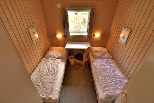Postel nebo postele na pokoji v ubytování Ferienhaus Typ C - AM WALDRAND