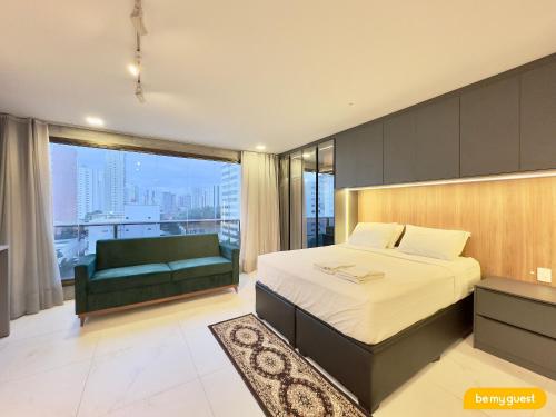 a bedroom with a bed and a couch and a window at Condomínio JSmart, localização ideal in Fortaleza
