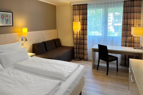 Ένα ή περισσότερα κρεβάτια σε δωμάτιο στο Garner Hotel Mainz by IHG