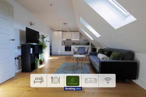 a living room with a couch and a kitchen at One Bedroom Apartment By Arhouse Apartments Short Lets & Serviced Accommodation Kingston With Free WiFi in Kingston upon Thames