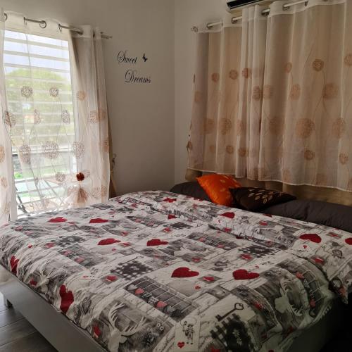 a bed with a quilt on it in a bedroom at Casa Madi in Bayahibe
