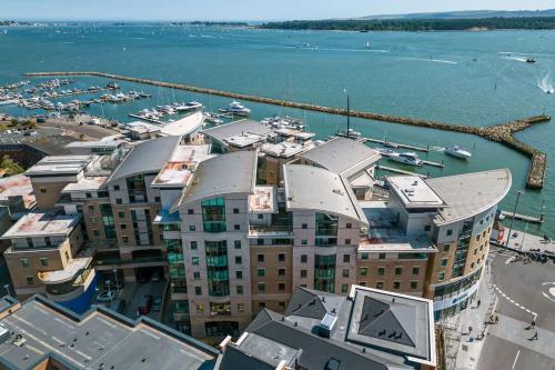 an aerial view of a building with a marina at Reflections - Balcony Views of Poole Harbour in Poole