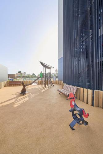 a playground with a monkey statue and a bench at The Editory by the Sea Lagos in Lagos