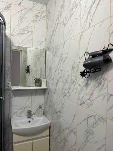 a bathroom with a sink and a mirror at Мини отель «Чайка» in Odesa