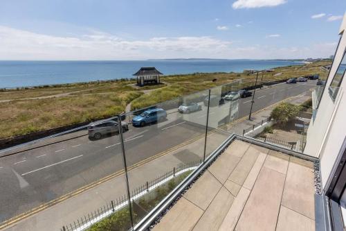 a view from the balcony of a building with a road at Beachcliff - On the Seafront with Two Balconies in Bournemouth