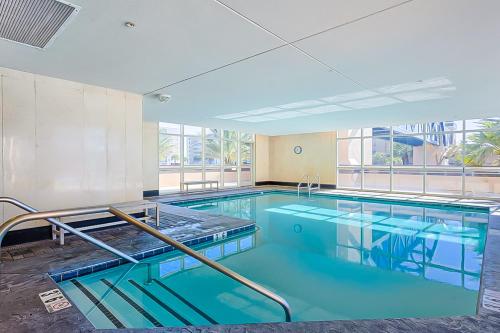 a large swimming pool with blue water in a building at Crystal Tower 705 in Gulf Shores