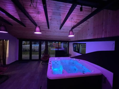 a hot tub in a room with purple lighting at Christiana-Rent in Cristian