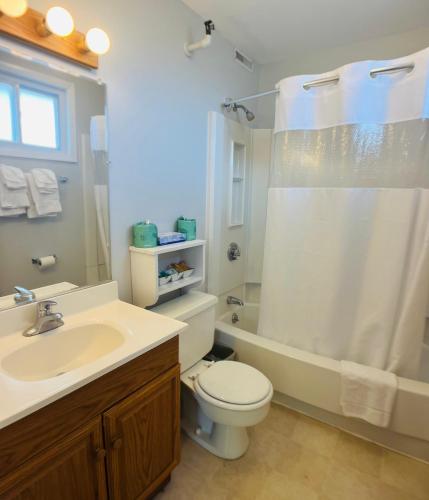 a bathroom with a sink and a toilet and a shower at Sunrise Motel in York
