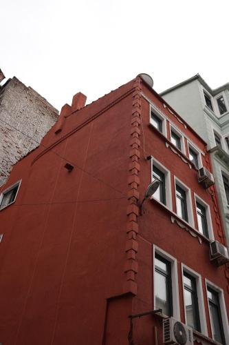 a red building with a bird on the side of it at Family Hotel Taksim in Istanbul