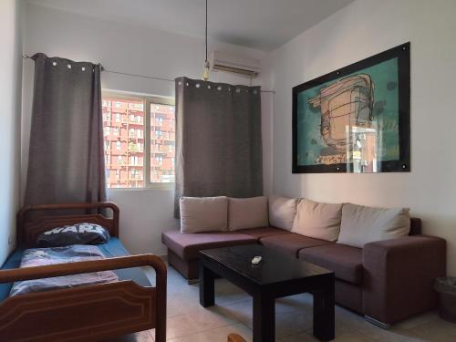a living room with a couch and a coffee table at Hostel Albania LoFT in Tirana