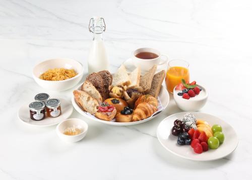 a table with a plate of breakfast foods and drinks at Mandarin Oriental Qianmen, Beijing in Beijing