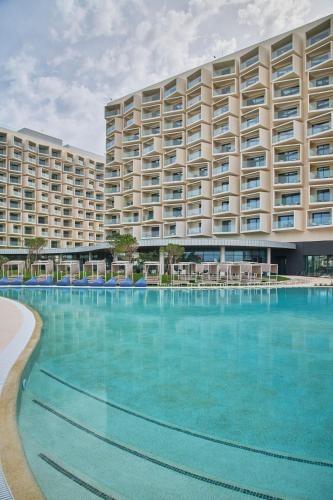 a large apartment building with a large swimming pool at The Editory by the Sea Lagos in Lagos