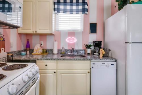 a kitchen with a sink and a white refrigerator at New 4 Bedroom Apt near DT Walk to restaurants in Nashville