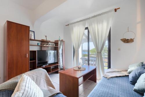 a living room with a couch and a tv at Apartment Eli in Banjole