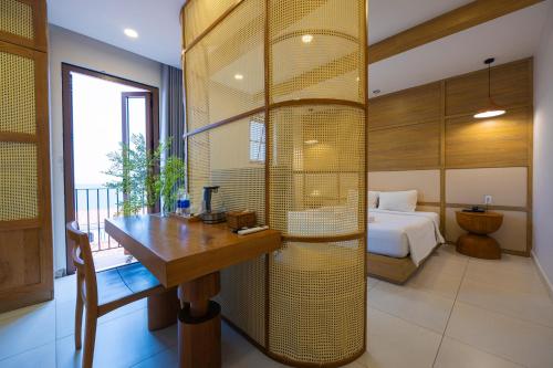 a bedroom with a bed and a desk in a room at Lotus Home Corner & Rooftop in Phu Quoc