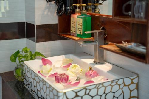 a bathroom sink with cupcakes on top of it at Hello Cambodia Hotel in Phumi Ta Phul