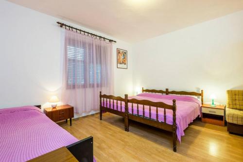 Postel nebo postele na pokoji v ubytování Apartments Nikola