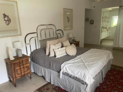 a bedroom with a bed with pillows on it at Excepcional casa en barrio privado in Yerba Buena