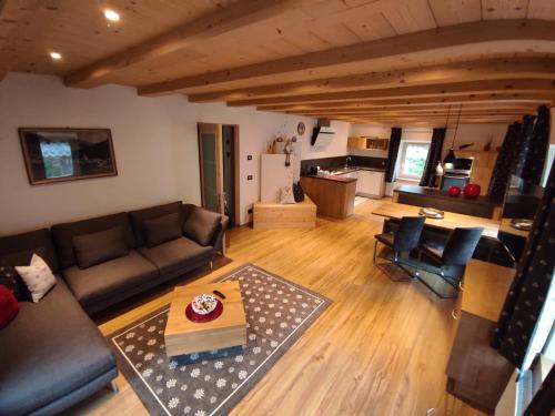 a living room with a couch and a table at Appartamenti Daberto Fabiola in Arabba