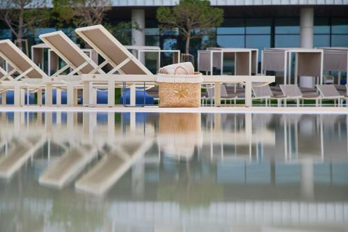 a basket sitting on the edge of a swimming pool at The Editory by the Sea Lagos in Lagos