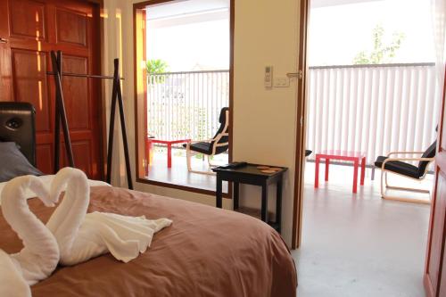 A bed or beds in a room at Barefeet Naturist Resort