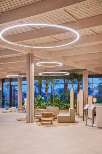 an office lobby with a circular light fixture at The Editory by the Sea Lagos in Lagos
