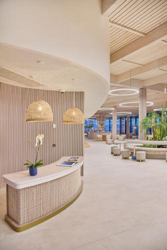 an office lobby with a reception desk and chairs at The Editory by the Sea Lagos in Lagos