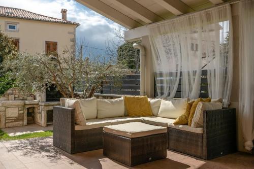 a couch sitting on a patio with a window at Villa Laura in Krnica
