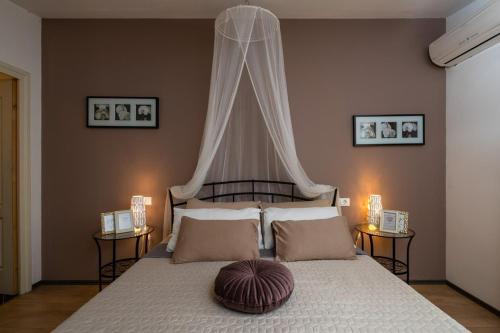 a bedroom with a large bed with a canopy at Villa Laura in Krnica