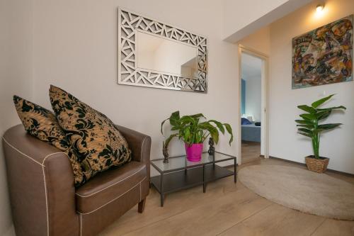 a living room with a chair and a table at Villa Laura in Krnica