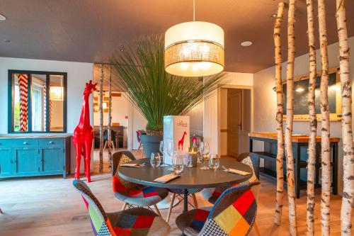a dining room with a table and chairs at Logis Hôtel Vannes Nord Le Clos Des Hortensias in Locqueltas