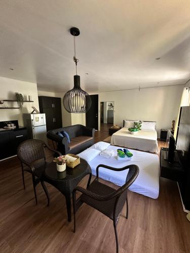 a hotel room with a bed and a couch at Kawayan Terrace - Boracay in Boracay