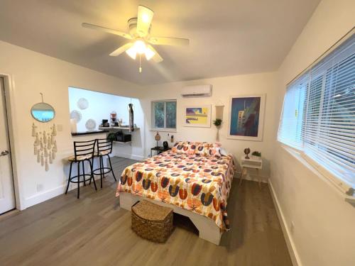 a bedroom with a bed and a ceiling fan at Tropical Paradise in Miracle Mile with Parking in Miami
