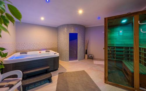 a large bathroom with a tub and a shower at Ferienwohnung 5235-1 in Drenje in Drenje